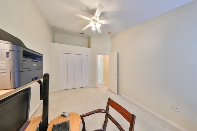 carpeted office space with ceiling fan