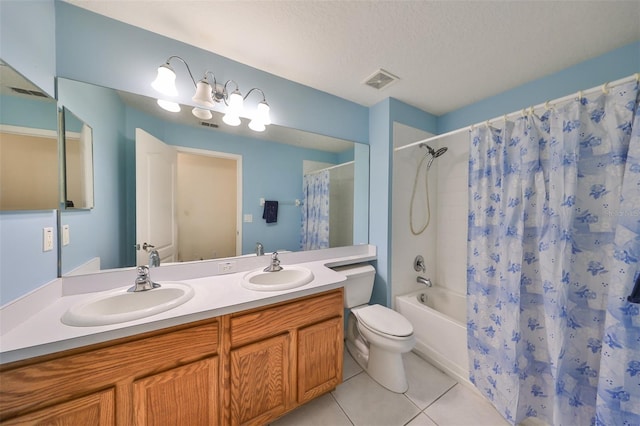 full bathroom with a textured ceiling, tile patterned flooring, toilet, shower / bath combo with shower curtain, and vanity