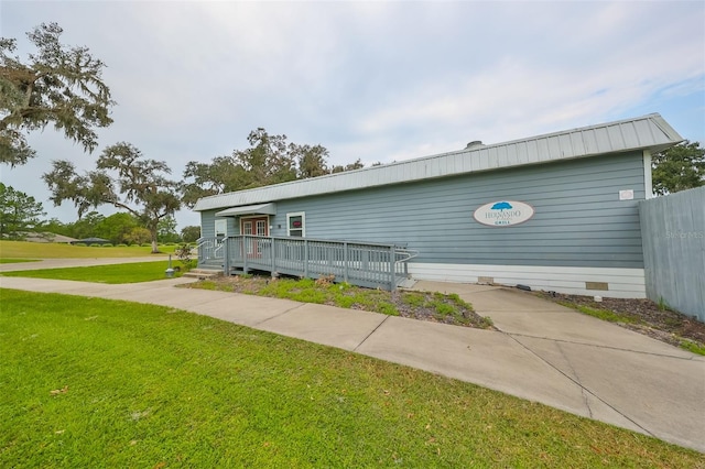 view of front of property with a deck and a front yard