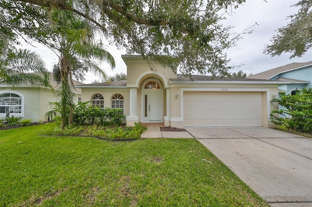 view of front facade with a front yard and a garage