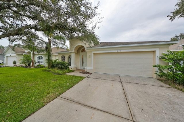 view of front of house with a front lawn and a garage