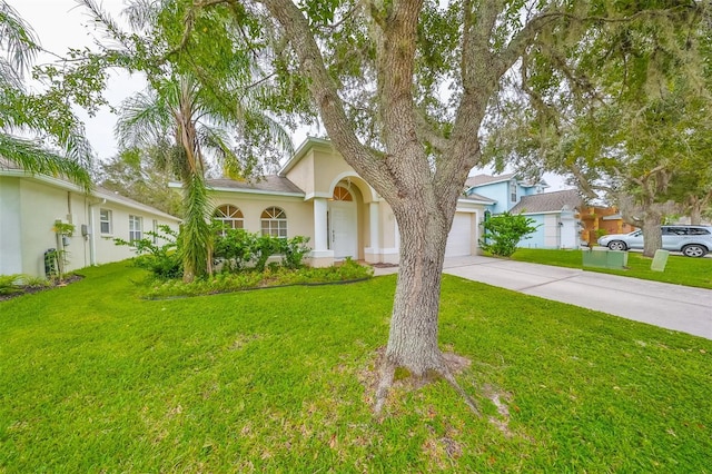 view of front of house featuring a garage and a front lawn