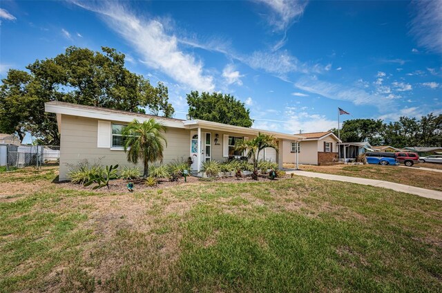 single story home with a front lawn