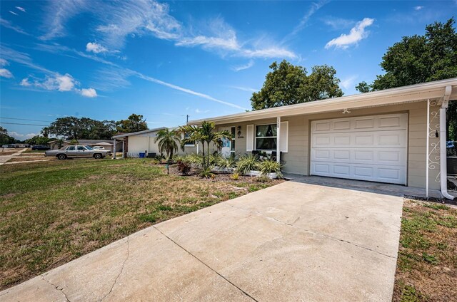 single story home with a garage and a front lawn