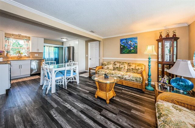 living room featuring sink, ornamental molding, dark hardwood / wood-style flooring, and a textured ceiling