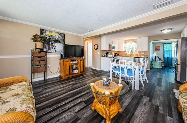 living room featuring sink, ornamental molding, dark hardwood / wood-style flooring, and a textured ceiling