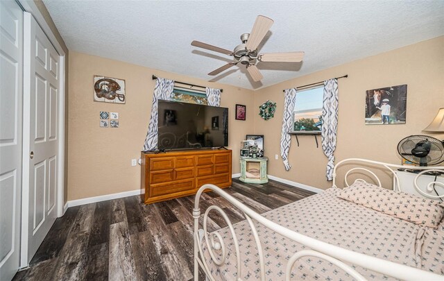 bedroom with a closet, dark hardwood / wood-style flooring, a textured ceiling, and ceiling fan