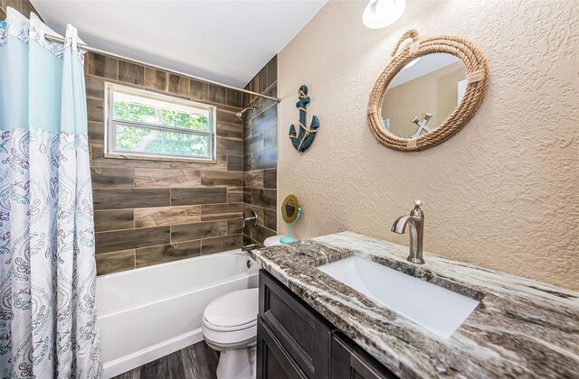 full bathroom with wood-type flooring, shower / bathtub combination with curtain, vanity, and toilet