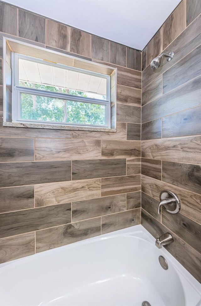 bathroom with washtub / shower combination