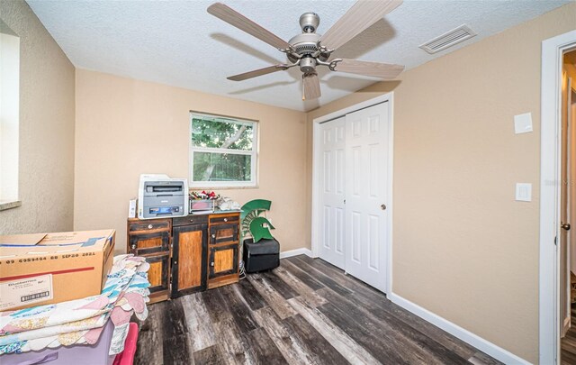 office featuring ceiling fan, dark hardwood / wood-style floors, and a textured ceiling