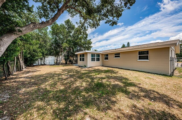 rear view of house with a yard