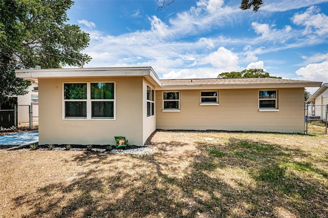 rear view of house with a yard