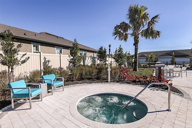 view of swimming pool featuring a patio and a community hot tub