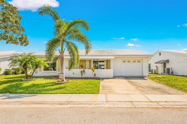 view of front of home featuring a garage, central AC, and a front yard