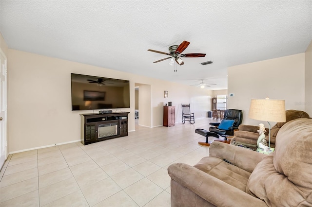 living room with a textured ceiling and light tile patterned flooring