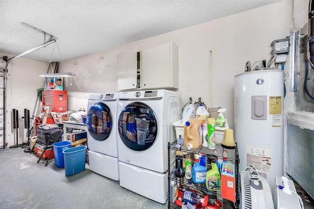 laundry area featuring cabinets, washing machine and clothes dryer, and electric water heater