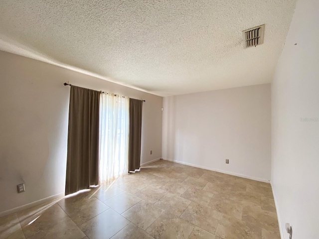 empty room featuring a textured ceiling