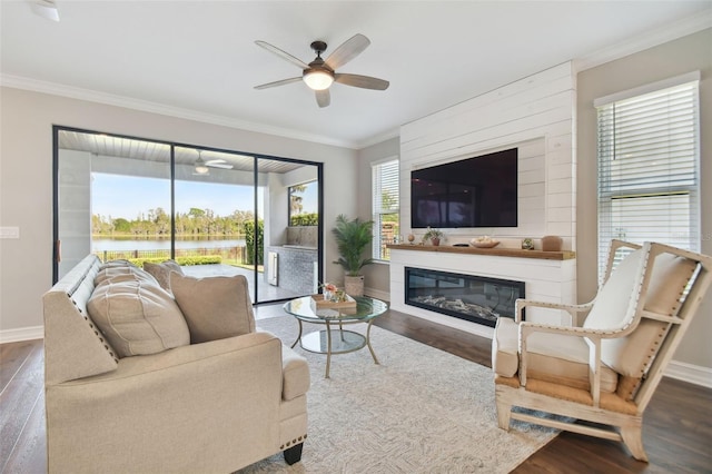 living room featuring crown molding, hardwood / wood-style floors, a healthy amount of sunlight, and ceiling fan