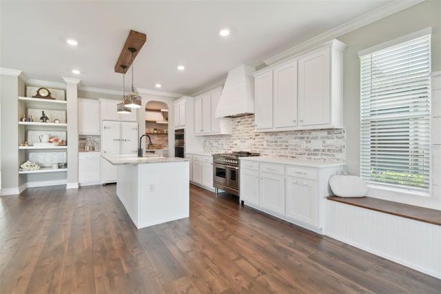 kitchen with appliances with stainless steel finishes, hanging light fixtures, dark hardwood / wood-style floors, and white cabinets