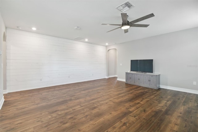 unfurnished living room with ceiling fan and dark hardwood / wood-style flooring