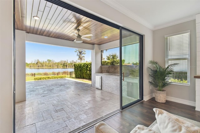 doorway featuring a water view, ceiling fan, wood ceiling, and plenty of natural light