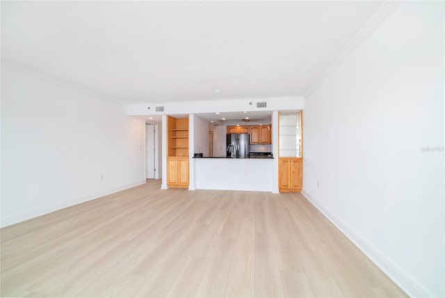 unfurnished living room with light hardwood / wood-style flooring and ornamental molding