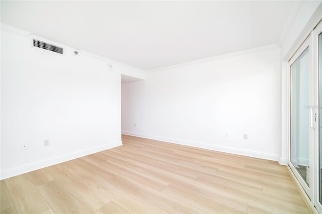 empty room featuring crown molding and light hardwood / wood-style flooring