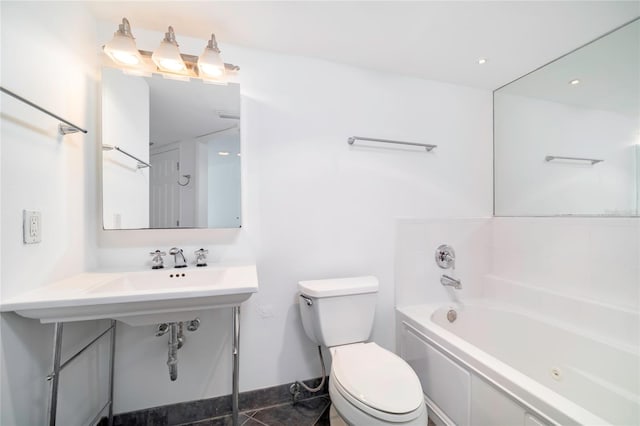 bathroom with a tub to relax in and toilet