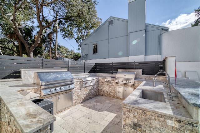 view of patio / terrace featuring sink, exterior kitchen, and area for grilling