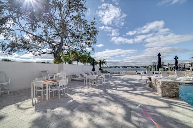 view of patio with a water view