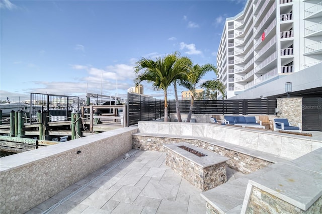 view of patio featuring an outdoor fire pit and a water view