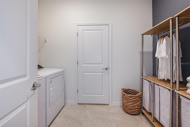 laundry area with separate washer and dryer and light tile patterned floors