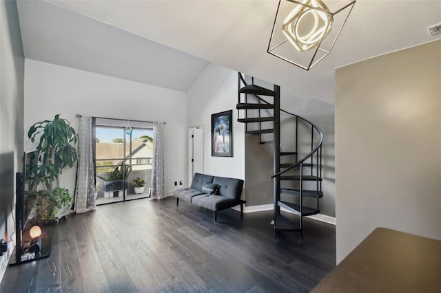 interior space featuring a chandelier, dark wood-type flooring, and lofted ceiling