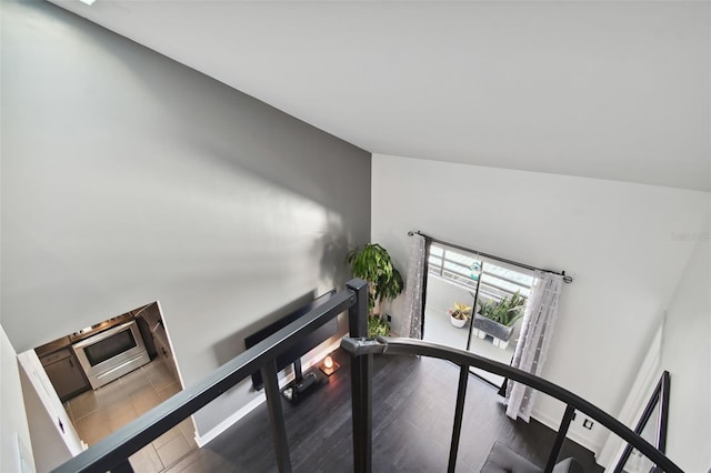 stairs with wood-type flooring and lofted ceiling