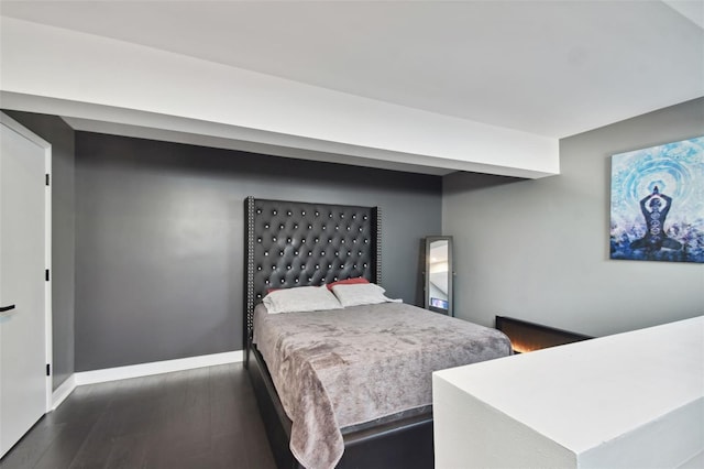 bedroom with dark wood-type flooring