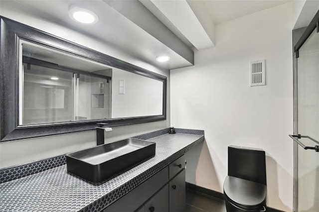 bathroom featuring vanity and a shower with door