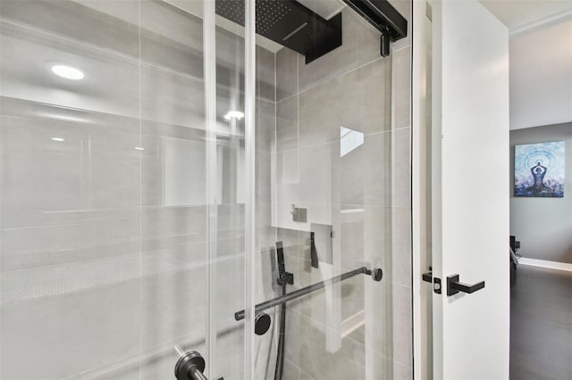 bathroom featuring a shower with shower door