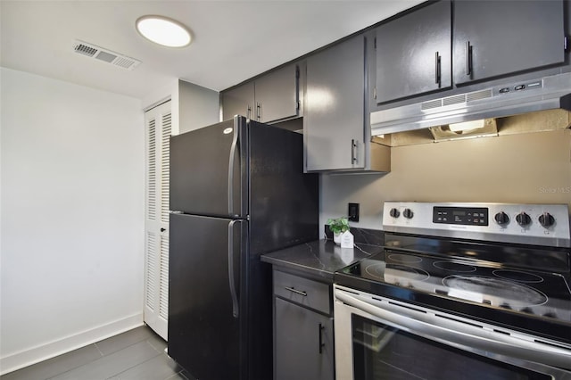 kitchen featuring black fridge and stainless steel electric range oven