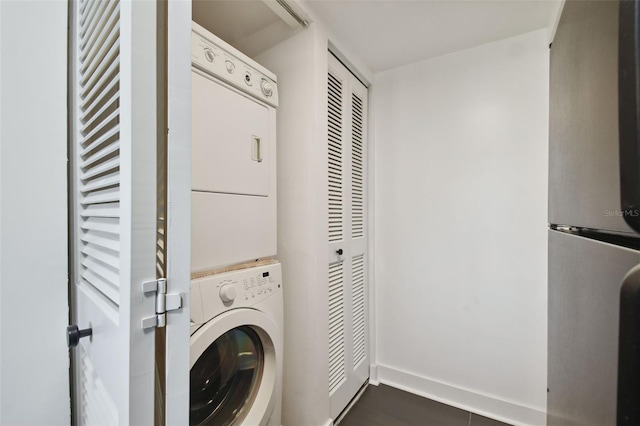 laundry area with stacked washer and dryer