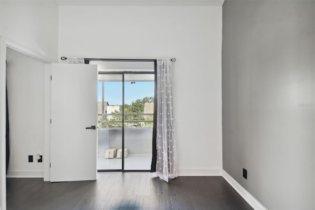 empty room featuring dark hardwood / wood-style flooring