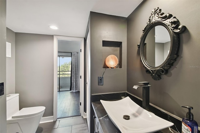 bathroom featuring vanity, toilet, and wood-type flooring