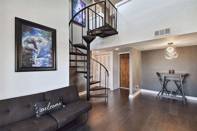 stairway featuring hardwood / wood-style floors and a chandelier