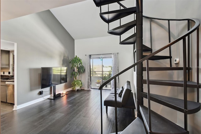 stairway featuring hardwood / wood-style floors and lofted ceiling