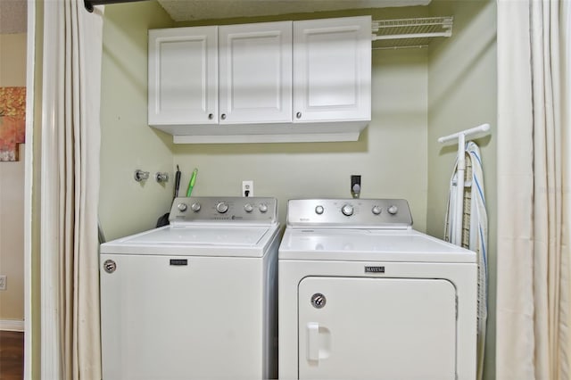 laundry area featuring cabinets and separate washer and dryer