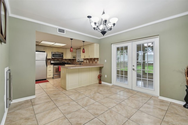 kitchen with stainless steel appliances, kitchen peninsula, tasteful backsplash, hanging light fixtures, and french doors