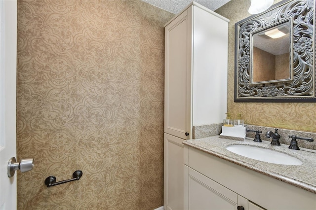 bathroom featuring vanity and a textured ceiling