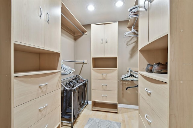 walk in closet featuring light hardwood / wood-style flooring