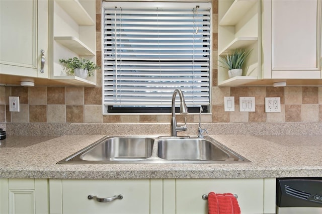 kitchen with sink, cream cabinets, and tasteful backsplash