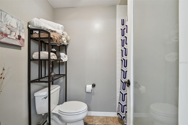 bathroom with tile patterned flooring and toilet