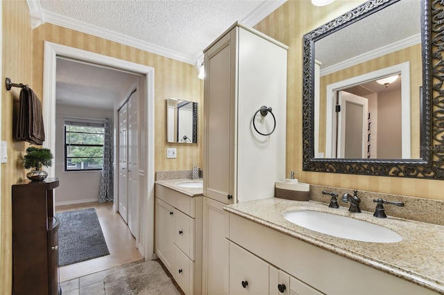 bathroom featuring vanity, a textured ceiling, and crown molding